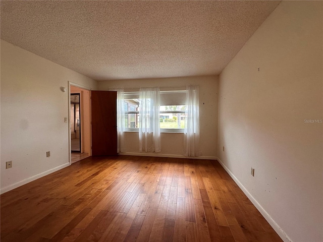 1214 56th St W Unit 1214, Bradenton, FL 34209 - unfurnished room with wood-type flooring, a textured ceiling, and baseboards