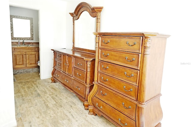 detailed view of wood finished floors and a sink
