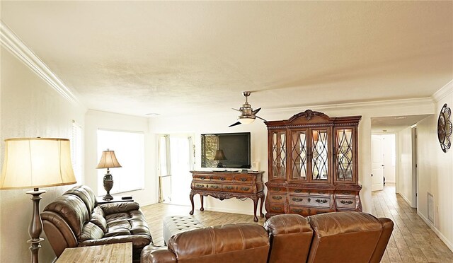 802 Capri Isles Blvd Unit 231, Venice, FL 34292 - living room featuring a ceiling fan, crown molding, light wood-type flooring, and baseboards