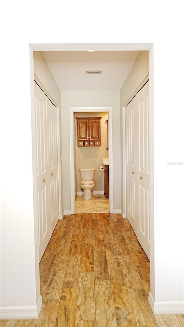 802 Capri Isles Blvd Unit 231, Venice, FL 34292 - hall featuring baseboards