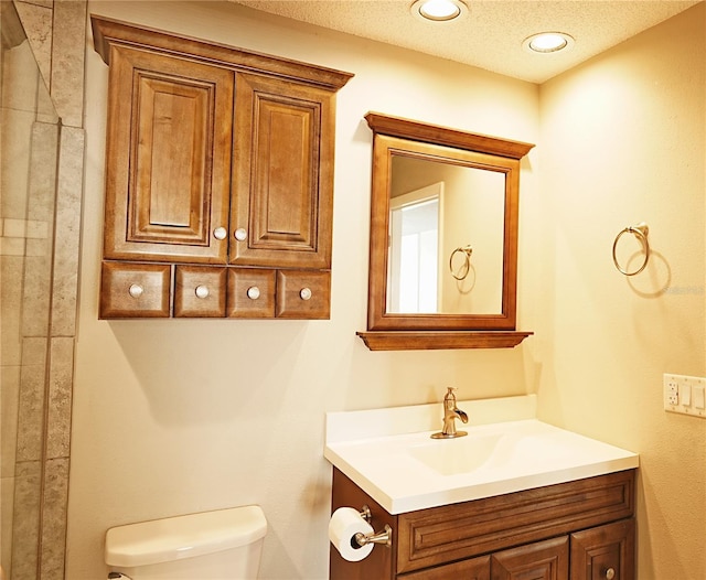 802 Capri Isles Blvd Unit 231, Venice, FL 34292 - bathroom with toilet, vanity, and a textured ceiling