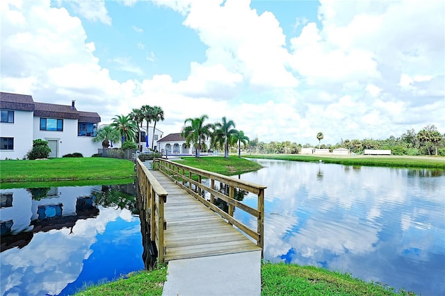 802 Capri Isles Blvd Unit 231, Venice, FL 34292 - dock area featuring a water view and a lawn