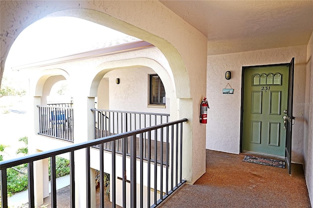 802 Capri Isles Blvd Unit 231, Venice, FL 34292 - doorway to property with a balcony and stucco siding