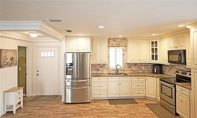 802 Capri Isles Blvd Unit 231, Venice, FL 34292 - kitchen with stainless steel appliances, a sink, stone countertops, tasteful backsplash, and crown molding