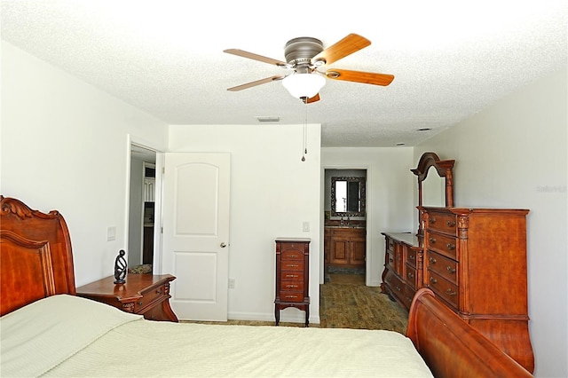 802 Capri Isles Blvd Unit 231, Venice, FL 34292 - bedroom with a textured ceiling, ceiling fan, and ensuite bathroom
