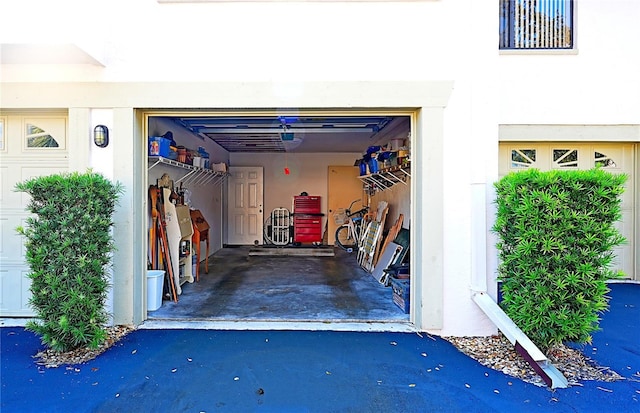 802 Capri Isles Blvd Unit 231, Venice, FL 34292 - garage with a garage door opener and asphalt driveway
