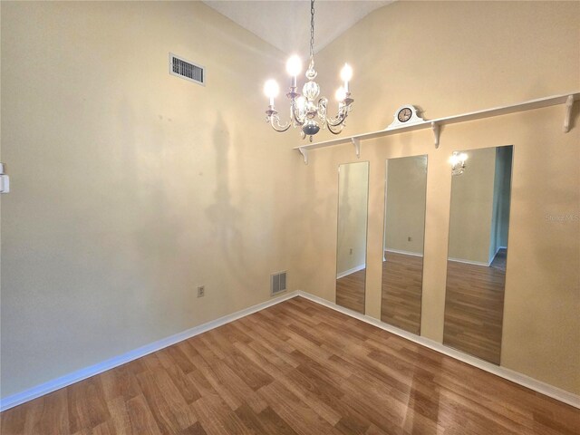 7201 29th Avenue Dr W Unit 306, Bradenton, FL 34209 - unfurnished dining area featuring wood finished floors, a chandelier, vaulted ceiling, and baseboards