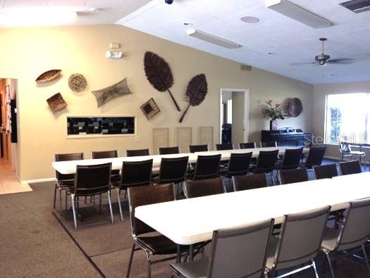 7201 29th Avenue Dr W Unit 306, Bradenton, FL 34209 - dining area featuring vaulted ceiling, dark colored carpet, and a ceiling fan