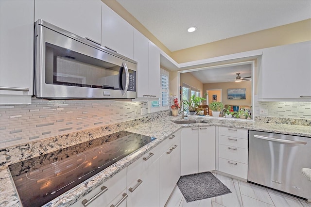 1432 Colony Pl, Venice, FL 34292 - kitchen featuring stainless steel appliances, a sink, backsplash, white cabinets, and recessed lighting