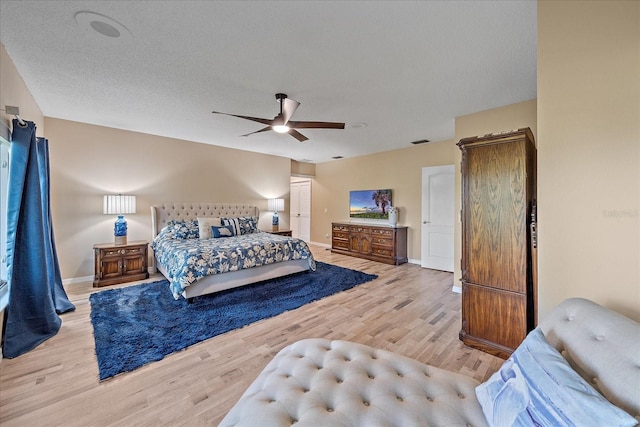 1432 Colony Pl, Venice, FL 34292 - bedroom with wood finished floors, baseboards, ceiling fan, and a textured ceiling