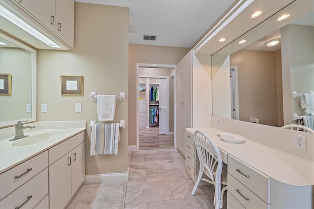 1432 Colony Pl, Venice, FL 34292 - full bathroom with baseboards, recessed lighting, marble look tiles, vanity, and a spacious closet