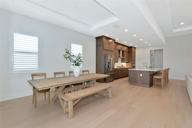 dining area featuring light wood-type flooring, baseboards, and recessed lighting