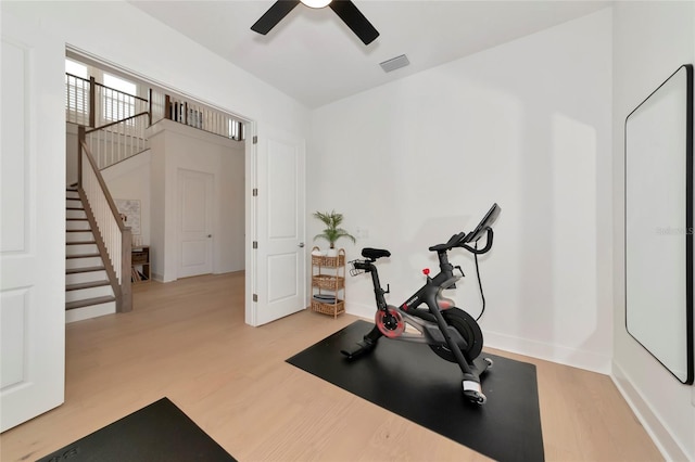 exercise area with wood finished floors and ceiling fan