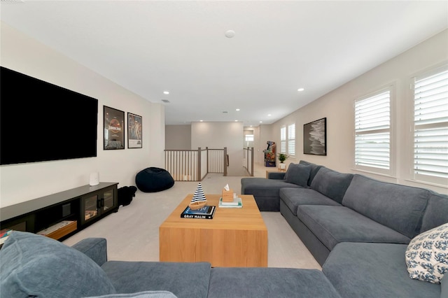 living area with light carpet and recessed lighting
