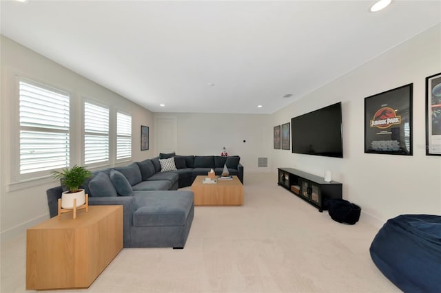 living area featuring light colored carpet and recessed lighting