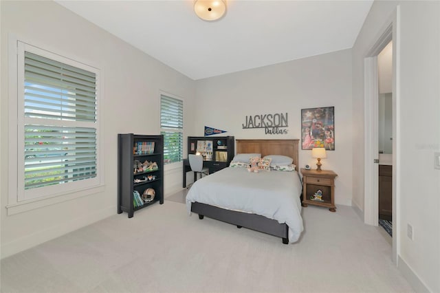 carpeted bedroom featuring baseboards