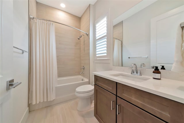 bathroom with shower / bath combination with curtain, toilet, vanity, and baseboards