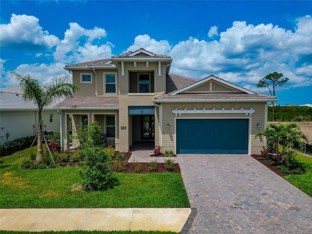 view of front of property with an attached garage, a front lawn, decorative driveway, and stucco siding