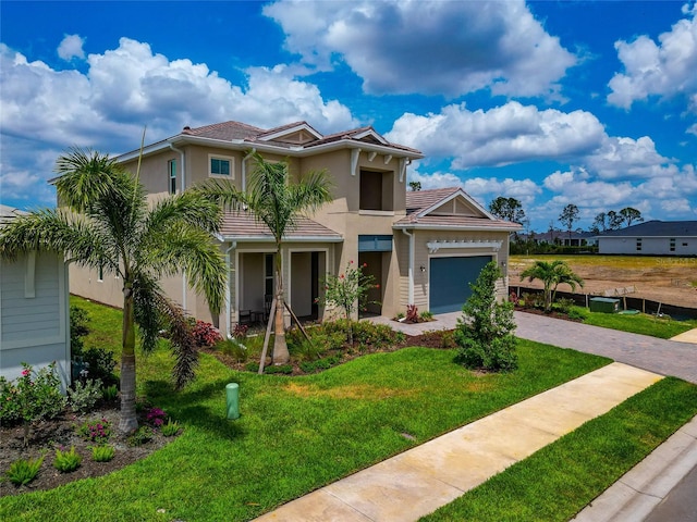 view of front facade featuring stucco siding, decorative driveway, a front yard, a garage, and a tiled roof