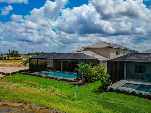 swimming pool with glass enclosure and a yard