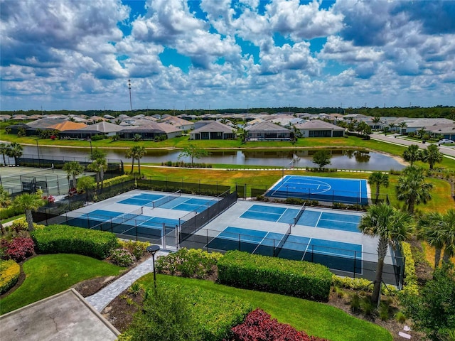 aerial view of residential area featuring a large body of water