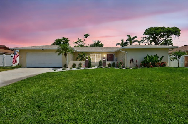 single story home featuring a garage, concrete driveway, and stucco siding