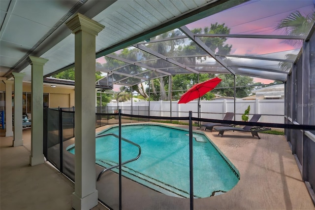 view of pool featuring a fenced backyard, a patio area, and glass enclosure