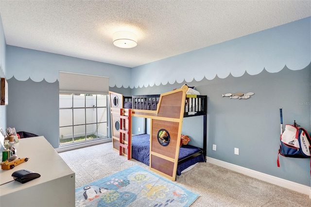 carpeted bedroom with a textured ceiling and baseboards