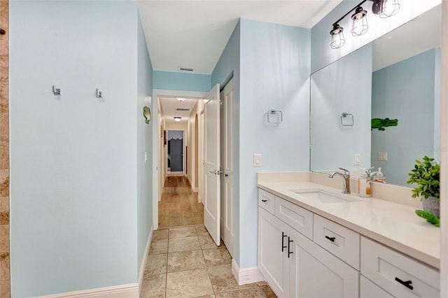 bathroom with baseboards and vanity