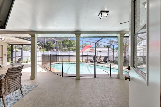 view of pool with a patio, a fenced backyard, and a lanai