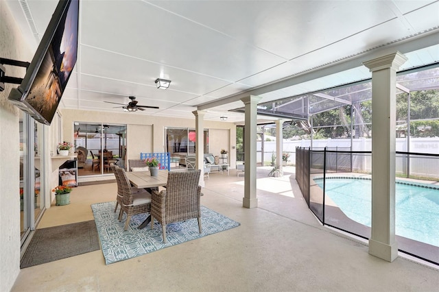 view of patio / terrace featuring fence, a ceiling fan, and glass enclosure