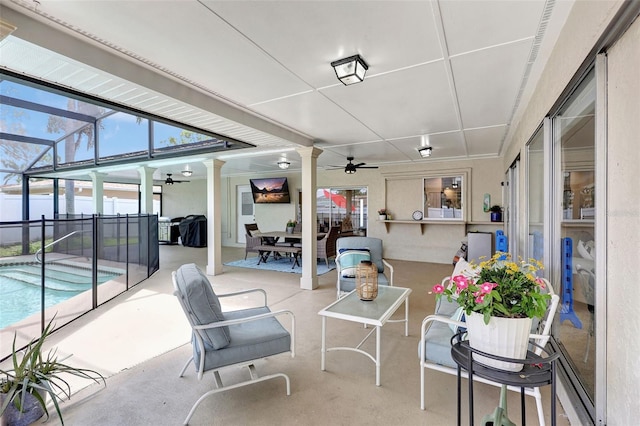 view of patio / terrace featuring ceiling fan and a lanai