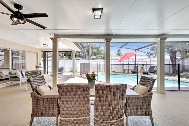 sunroom / solarium featuring ceiling fan, a pool, and plenty of natural light