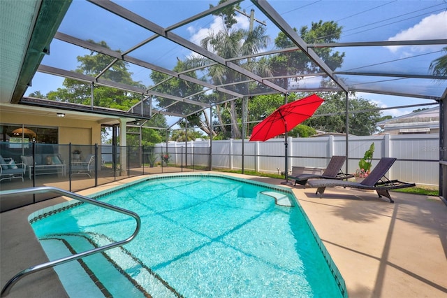 view of swimming pool with a patio, a fenced backyard, and a lanai