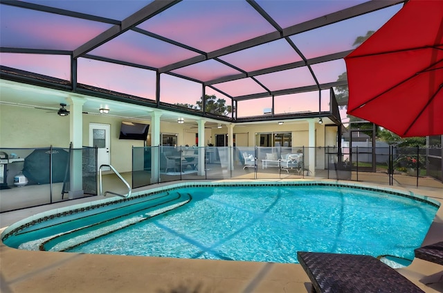view of pool featuring a ceiling fan, a patio, a lanai, and fence