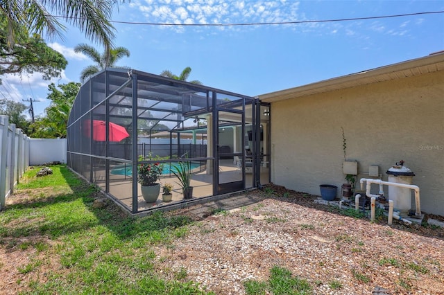 fenced backyard with a patio and a lanai