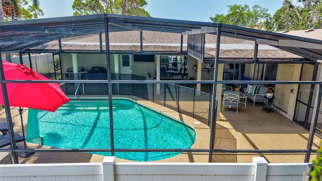 outdoor pool featuring a lanai and a patio area
