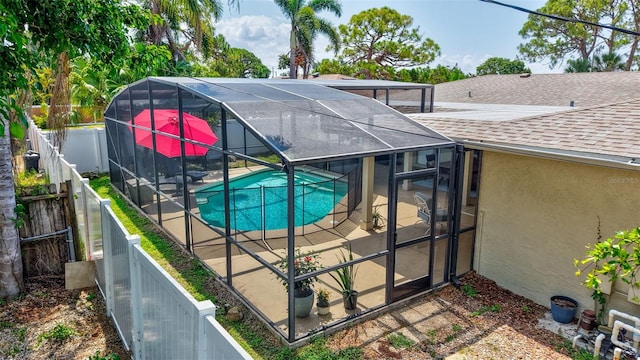 view of pool featuring a fenced backyard, a patio, and glass enclosure