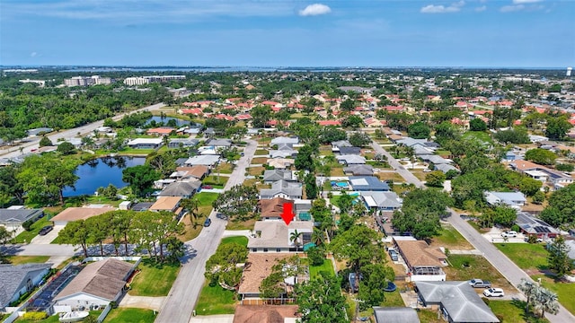 view of property location featuring a nearby body of water and nearby suburban area