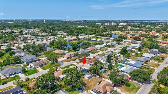 aerial view of property and surrounding area with a large body of water and nearby suburban area