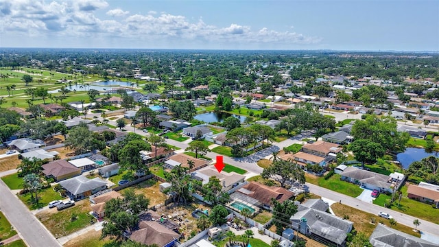 aerial view of property's location with a large body of water and nearby suburban area