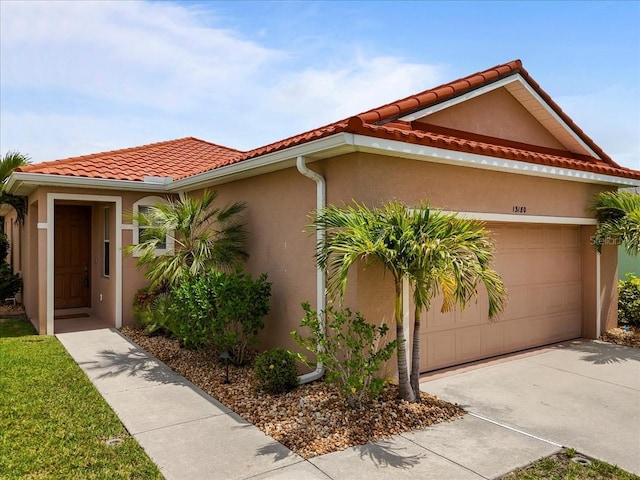 13180 SW Pembroke Cir N, Lake Suzy, FL 34269 - mediterranean / spanish home with stucco siding, concrete driveway, a garage, and a tiled roof