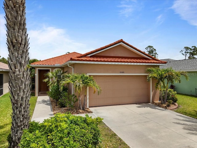 13180 SW Pembroke Cir N, Lake Suzy, FL 34269 - mediterranean / spanish-style home with a garage, stucco siding, concrete driveway, and a tiled roof