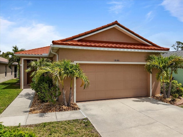 13180 SW Pembroke Cir N, Lake Suzy, FL 34269 - mediterranean / spanish home with a garage, concrete driveway, stucco siding, and a tiled roof