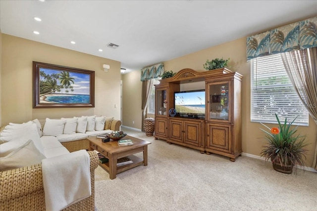 13180 SW Pembroke Cir N, Lake Suzy, FL 34269 - living room with light colored carpet, baseboards, and recessed lighting