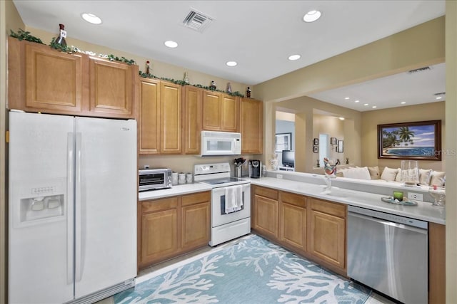 13180 SW Pembroke Cir N, Lake Suzy, FL 34269 - kitchen featuring white appliances, a sink, light countertops, recessed lighting, and open floor plan