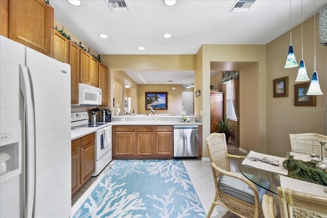 13180 SW Pembroke Cir N, Lake Suzy, FL 34269 - kitchen featuring white appliances, light countertops, brown cabinets, recessed lighting, and hanging light fixtures