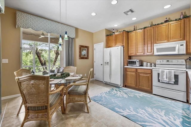 13180 SW Pembroke Cir N, Lake Suzy, FL 34269 - kitchen with white appliances, baseboards, brown cabinets, and recessed lighting