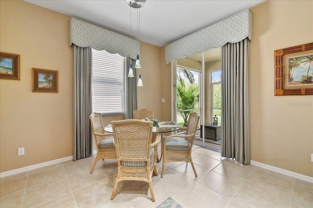 13180 SW Pembroke Cir N, Lake Suzy, FL 34269 - dining room with baseboards and light tile patterned flooring