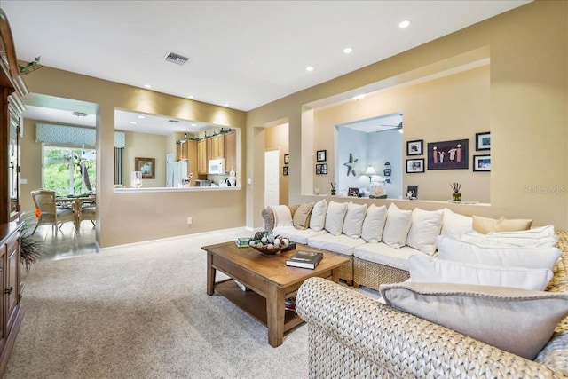 13180 SW Pembroke Cir N, Lake Suzy, FL 34269 - living room with light colored carpet, recessed lighting, and a ceiling fan